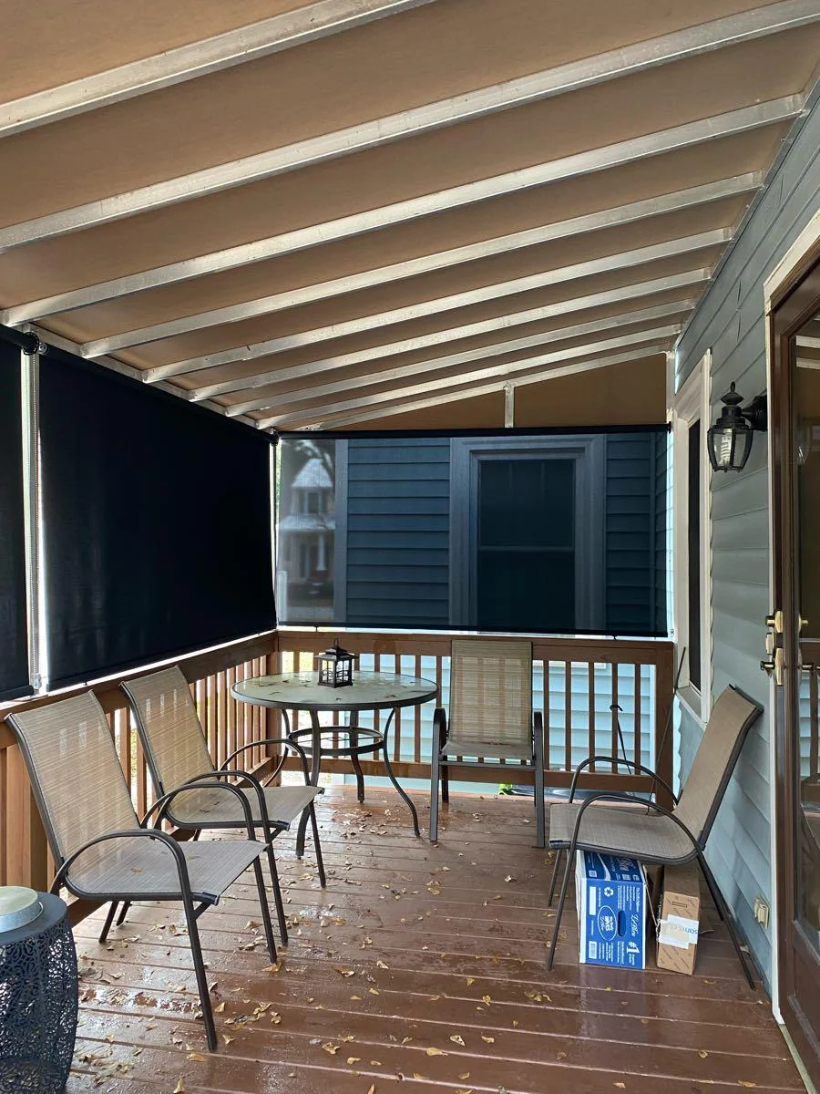 Covered porch with dark shade installations