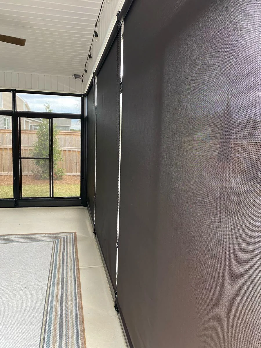 Dark roller shades fitted along a covered porch, shown on the Coastal Hangers business profile